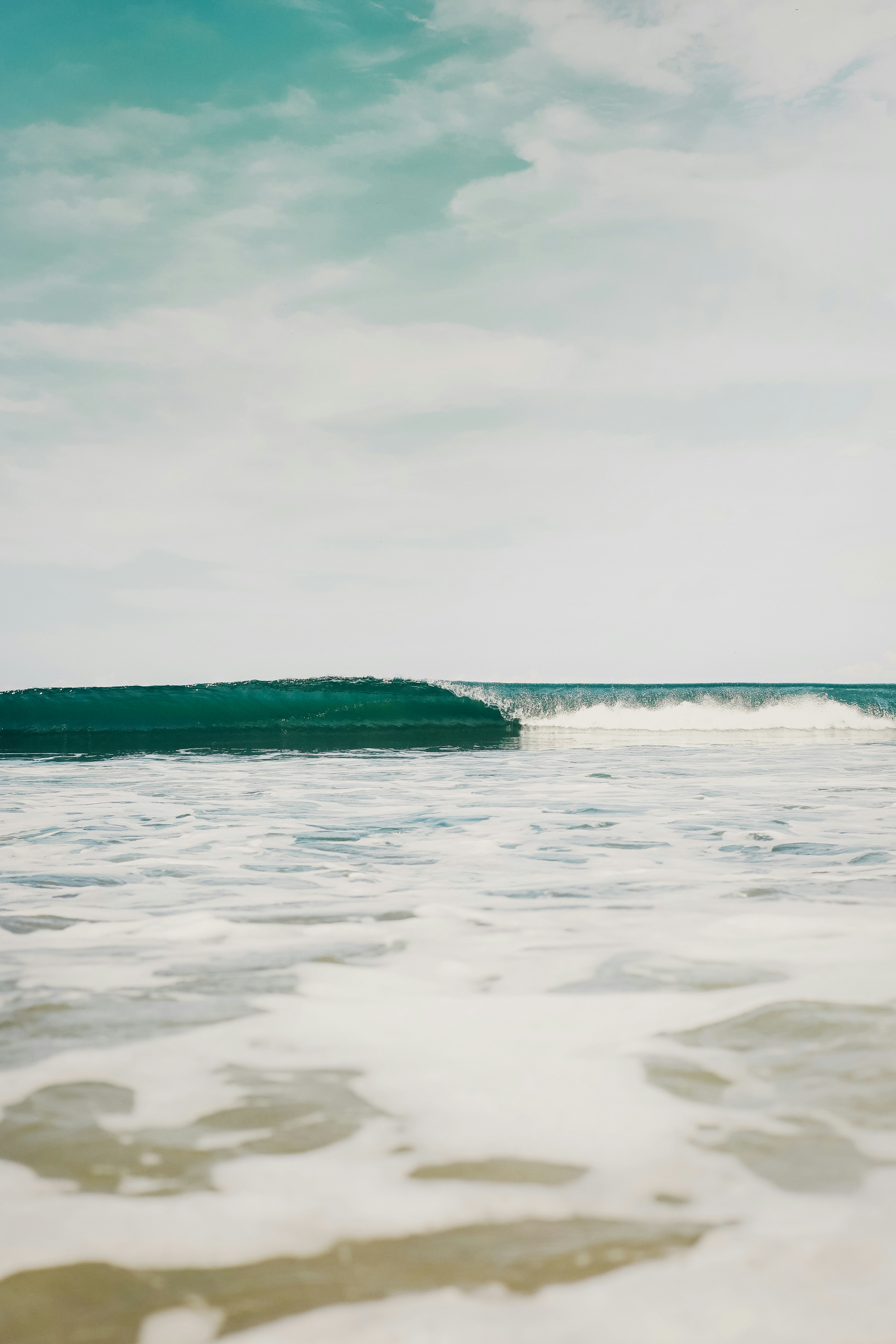 body-of-water-under-white-sky-during-daytime