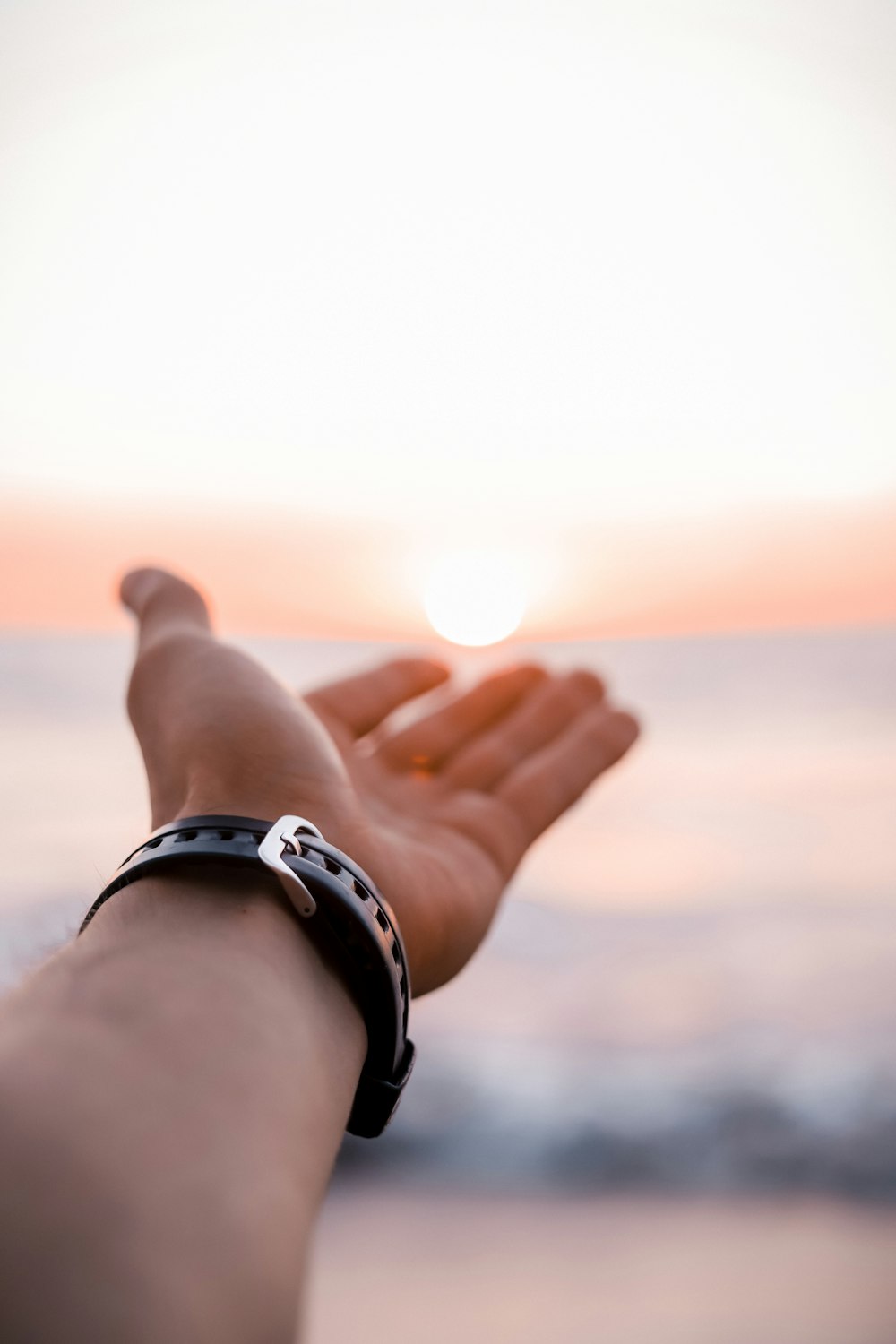 person wearing silver link bracelet watch