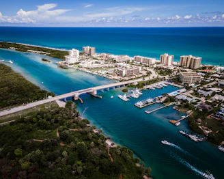 aerial view of city buildings near body of water during daytime
