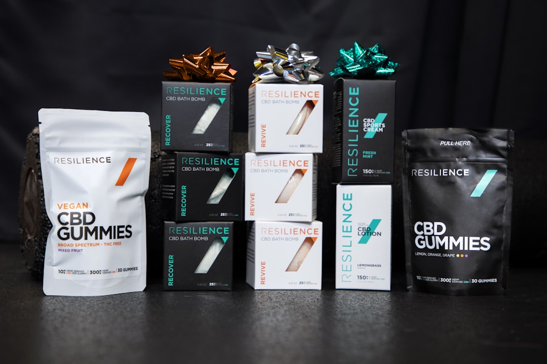 black and white labeled box, Resilience CBD products with black background and fitness equipment.
