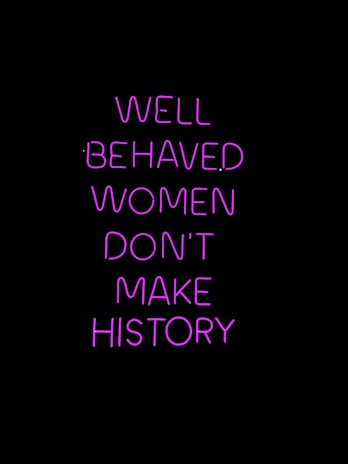 Neon pink text on a black background conveying a powerful message about the impact of behavior on making history.