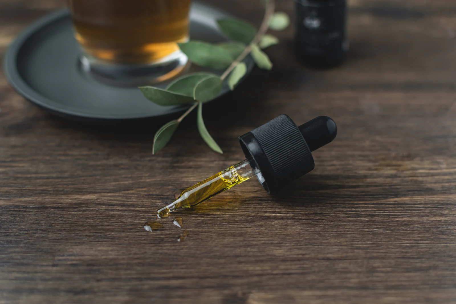 Essential oil bottles beside fresh herbs