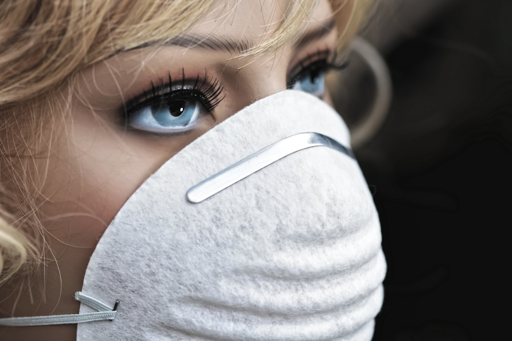 woman in gray turtleneck shirt wearing white face mask