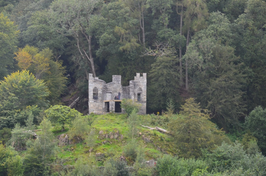 gray concrete building on green grass field,