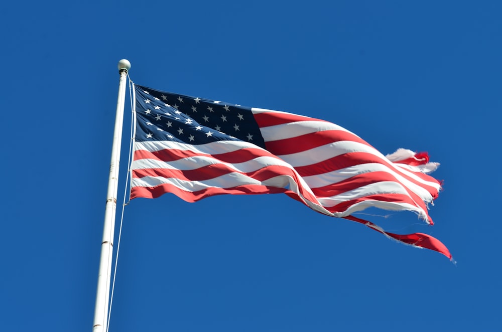 us a flag under blue sky during daytime