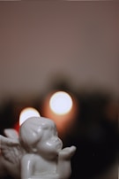 Close-up of hands gently holding a small angel figurine, symbolizing guidance.