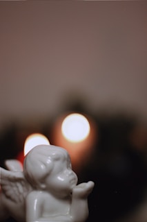 Close-up of hands gently holding a small angel figurine, symbolizing guidance.
