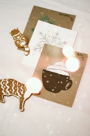 A cozy scene of a festive table scattered with vintage and cartoon-style Christmas cards.