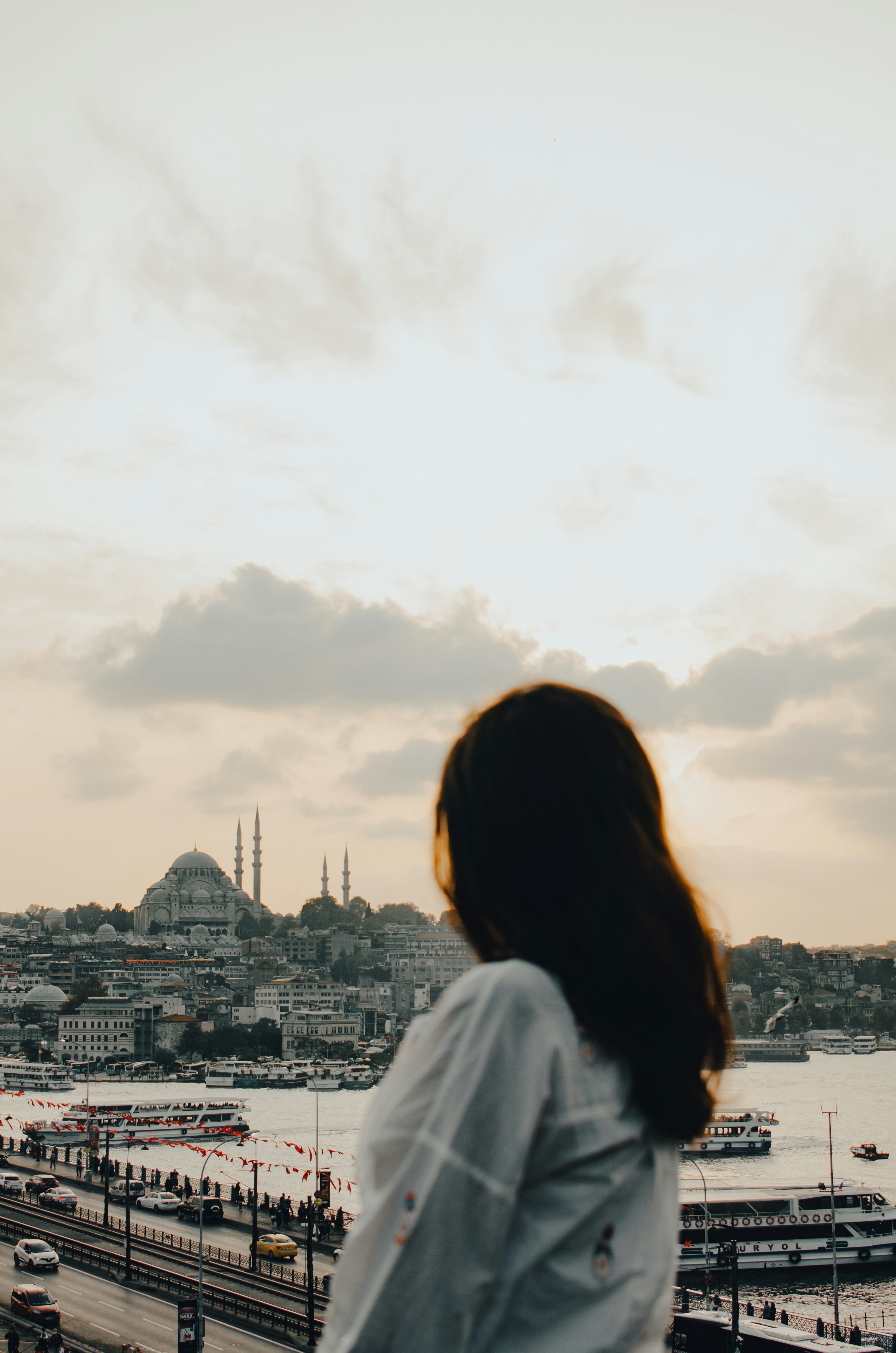 woman in white shirt standing on top of building during daytime