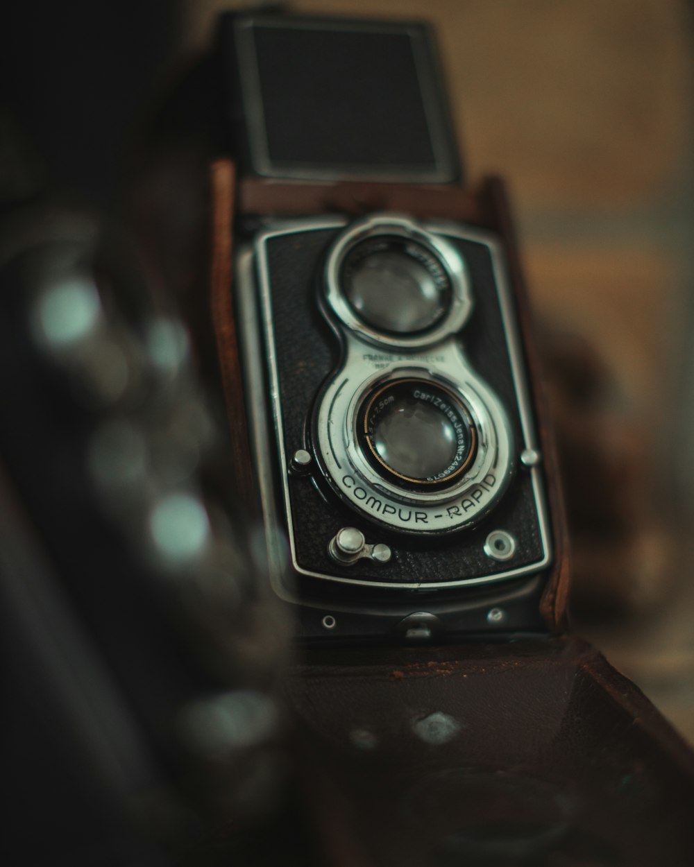 black and silver camera on brown wooden table