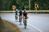 men riding bicycle on road during daytime
