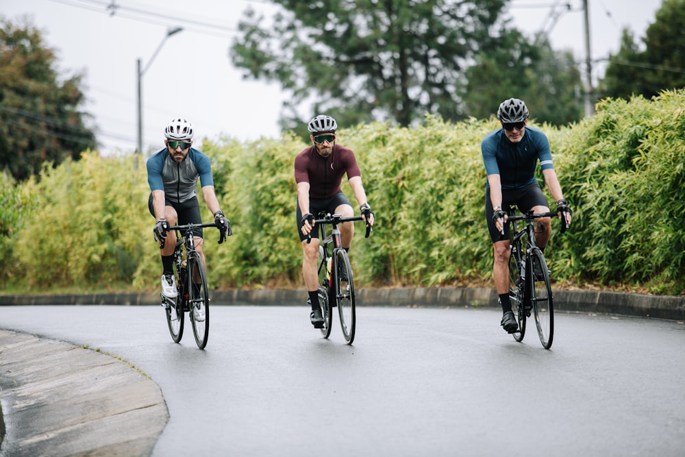 men riding on bicycle on road during daytime