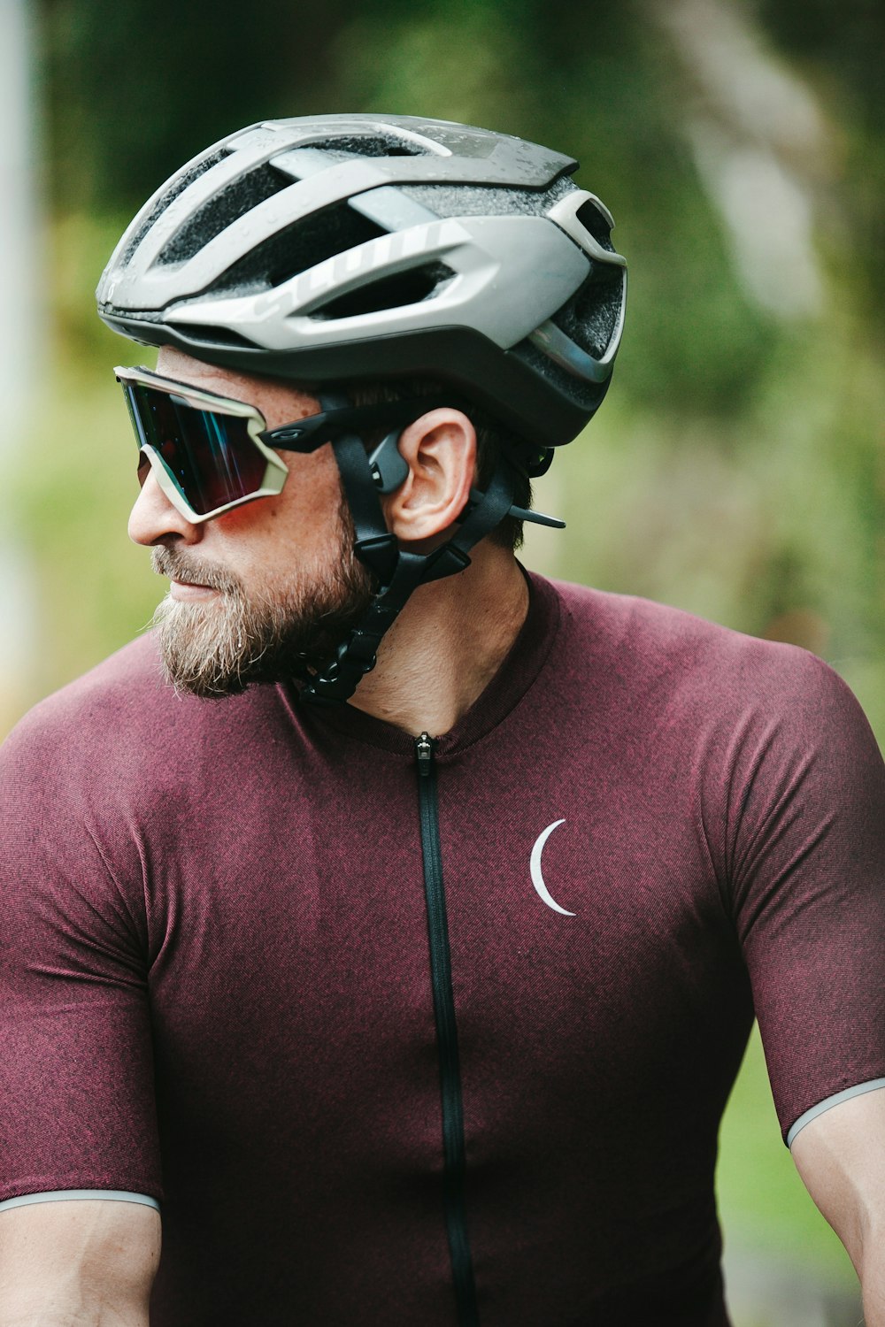 man in purple nike crew neck t-shirt wearing black and white helmet