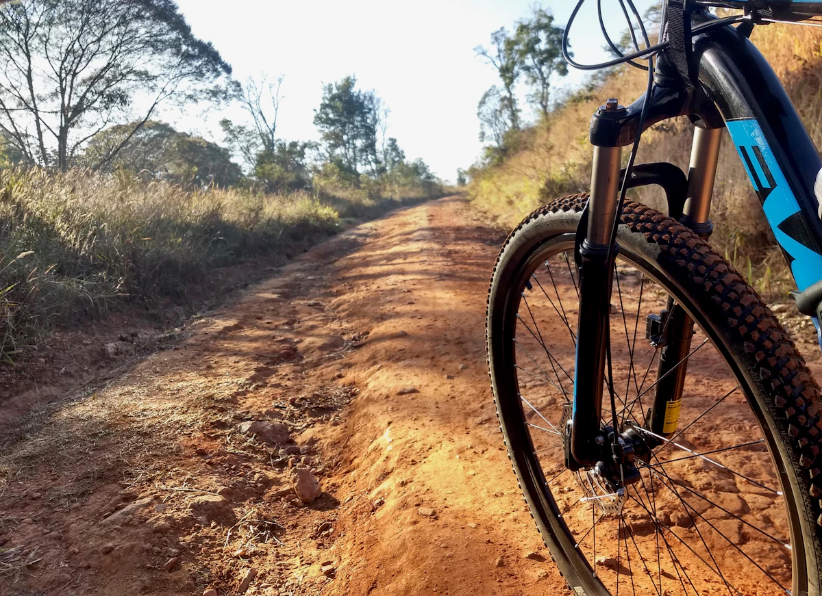 Black hardtail mountain bike on a dirt trail