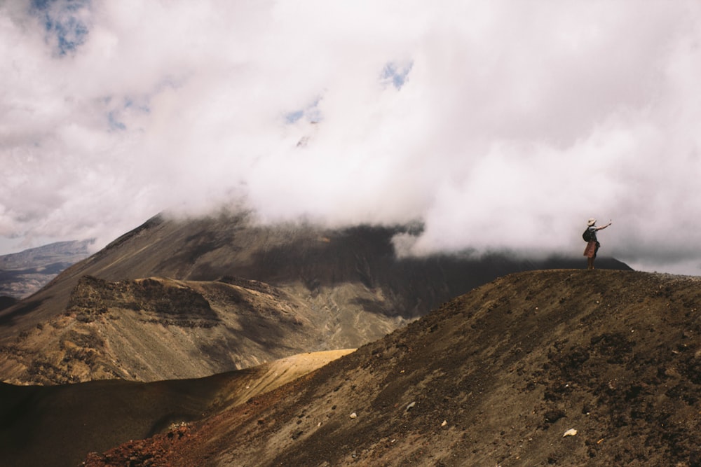 brown and green mountain under white clouds during daytime