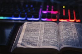 Close-up of an open book titled 'GPTAwake' with glowing text and ethereal light.