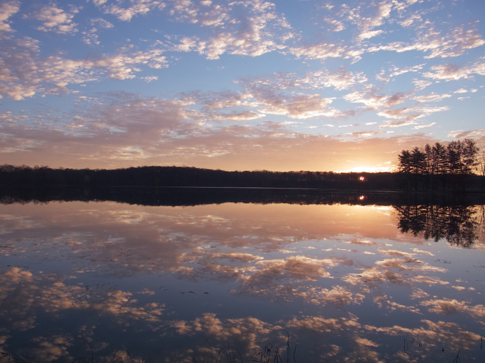 body of water under blue sky during sunset