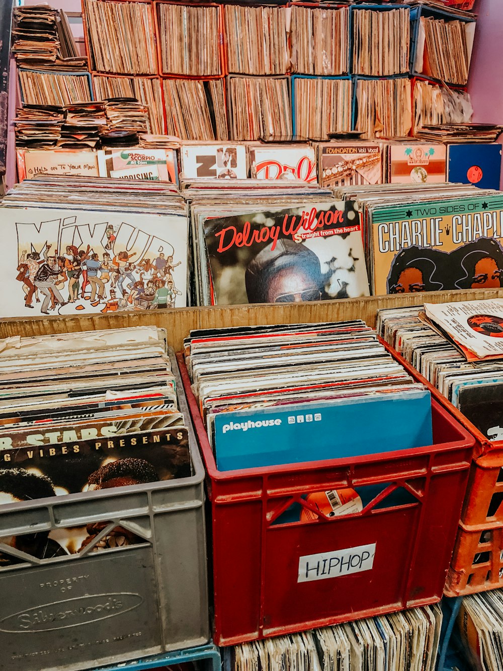 assorted books on red plastic crate