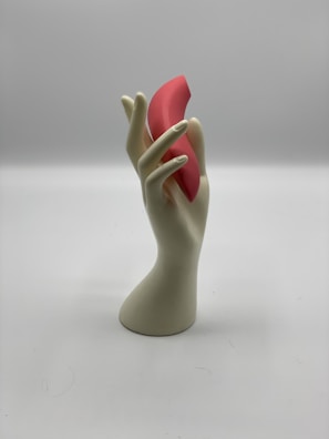 Robotic hand gently gripping a fragile, irregular-shaped object in industrial setting