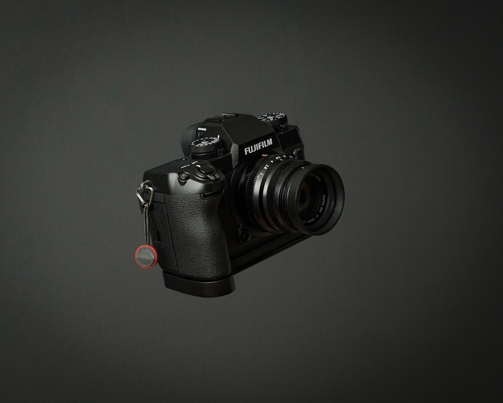 black dslr camera on black surface