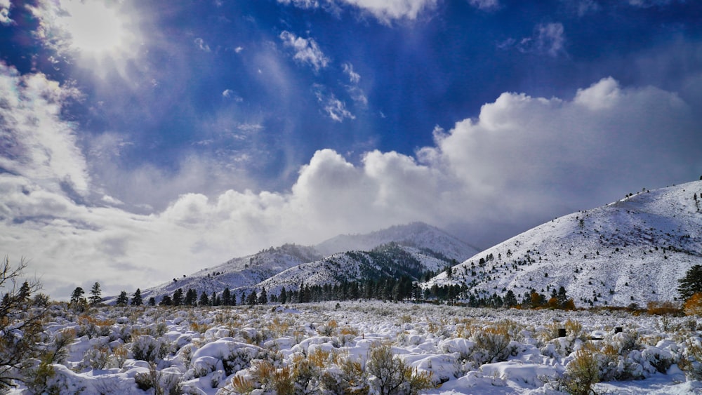 snow covered mountain under blue sky and white clouds during daytime