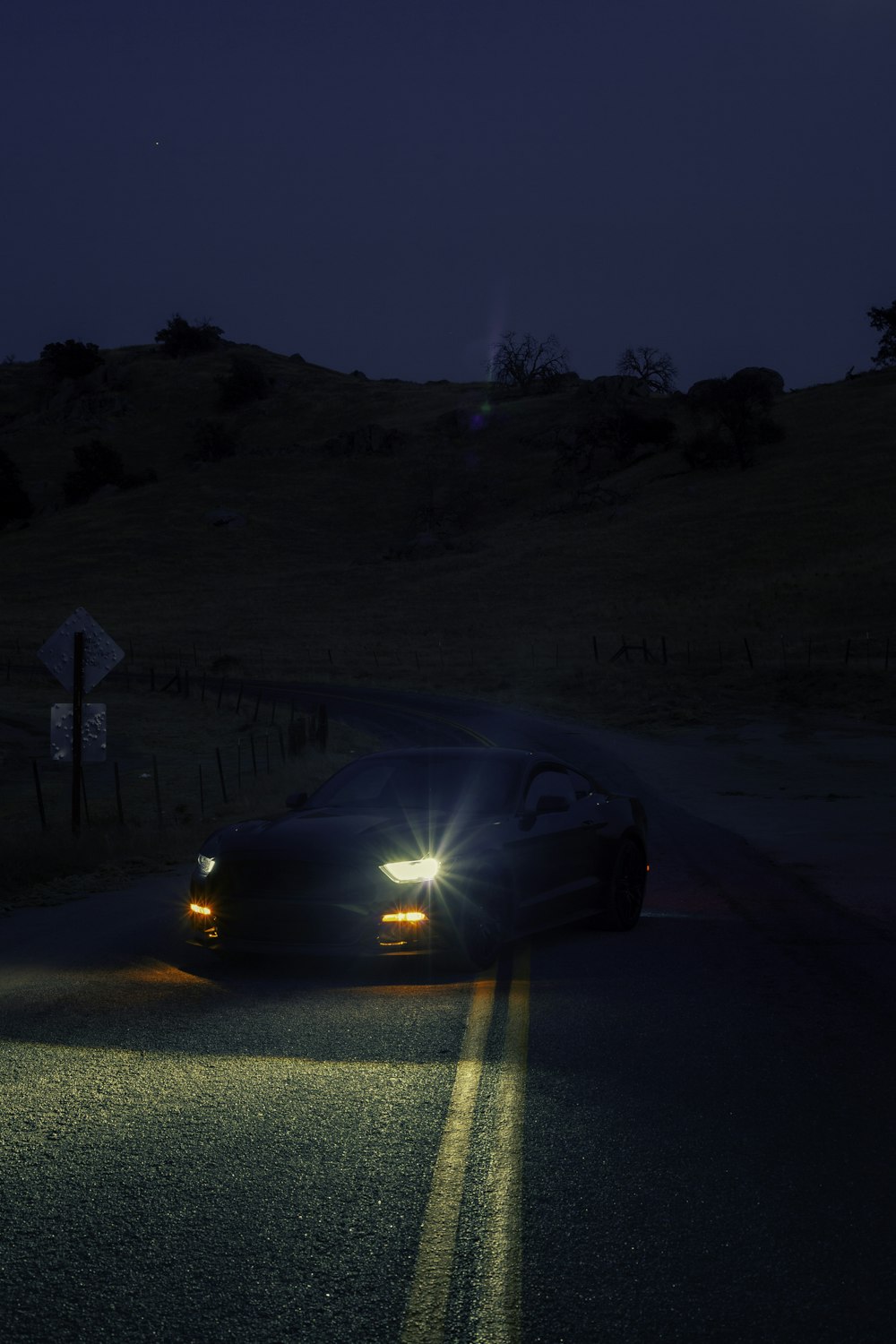 black car on road during night time