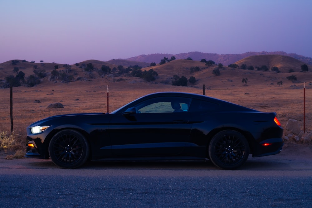 black coupe on brown sand during daytime