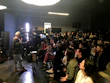 Angela Fernandez presenting at a professional seminar with attentive audience