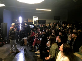 A student proudly presenting a research project during a Light Cluster seminar.