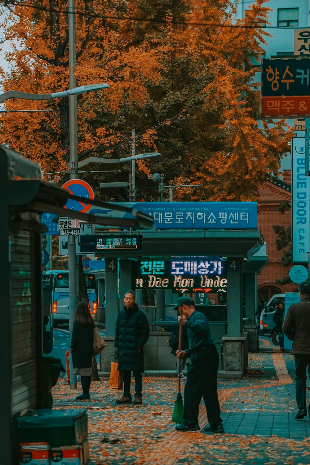 people walking on sidewalk near store during daytime