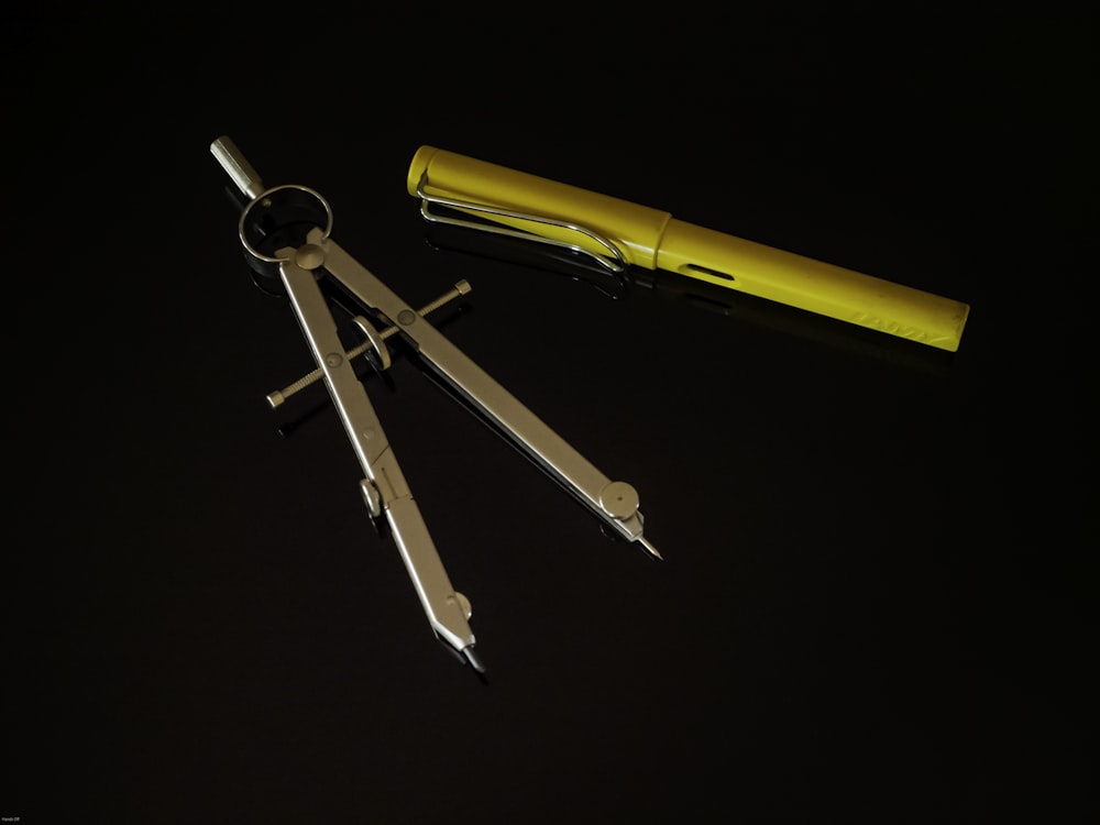 yellow and silver metal tool