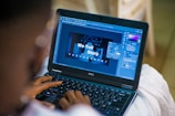 person using black laptop computer