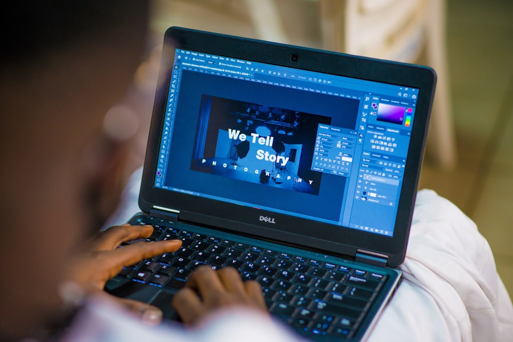 person using black laptop computer