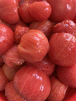Close-up of the rich red tomato paste texture being poured, reflecting the brand’s commitment to premium quality.