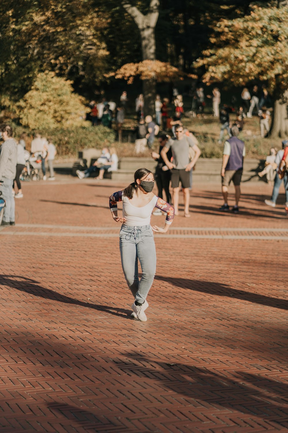 woman in white tank top and white pants running on brown field during daytime