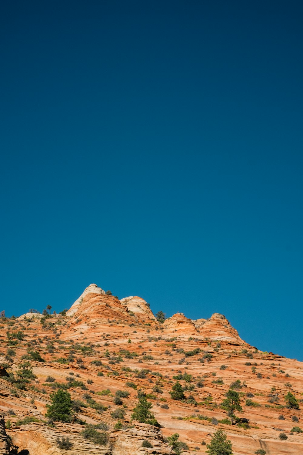 brown rocky mountain under blue sky during daytime