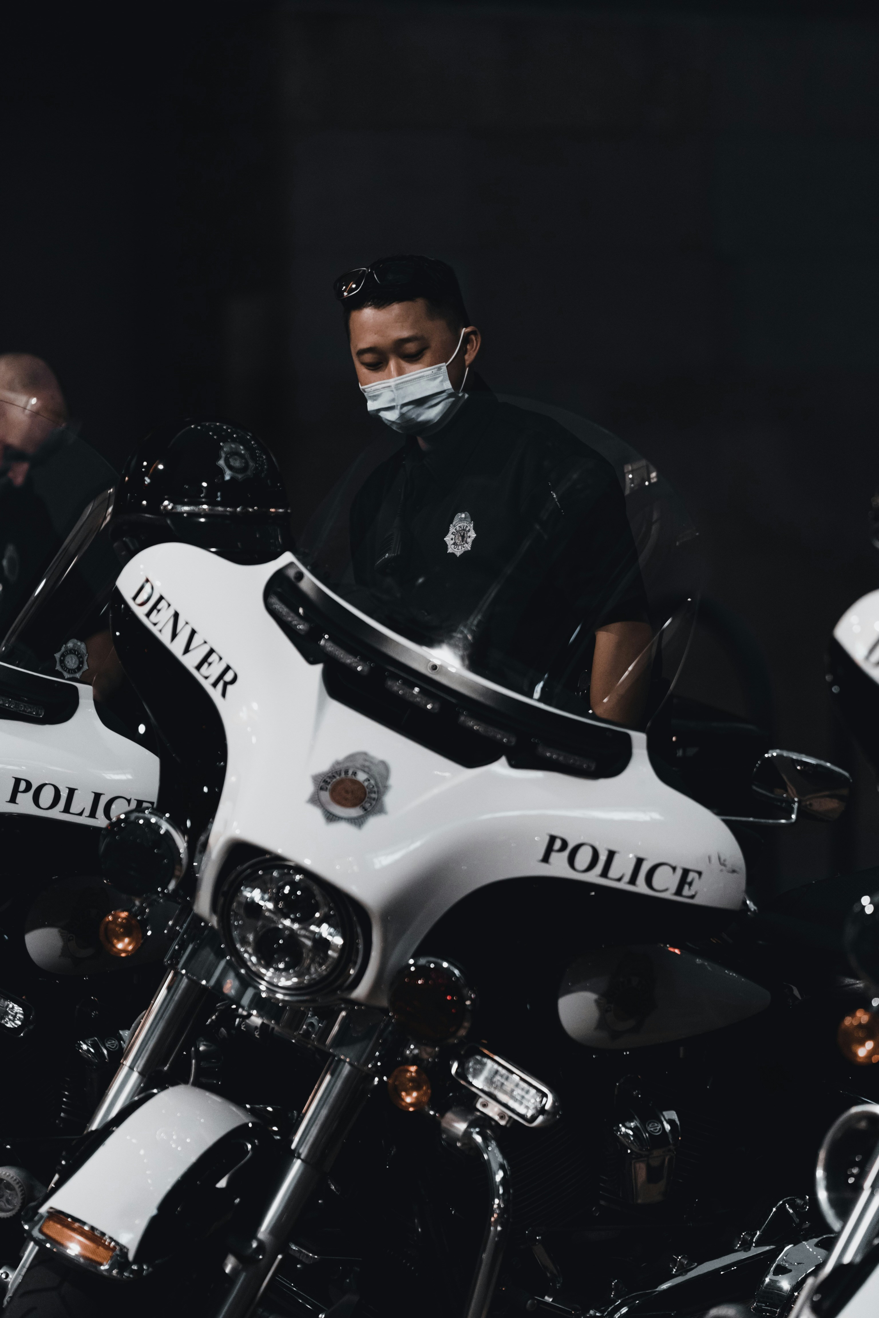 man in black jacket riding white and black motorcycle