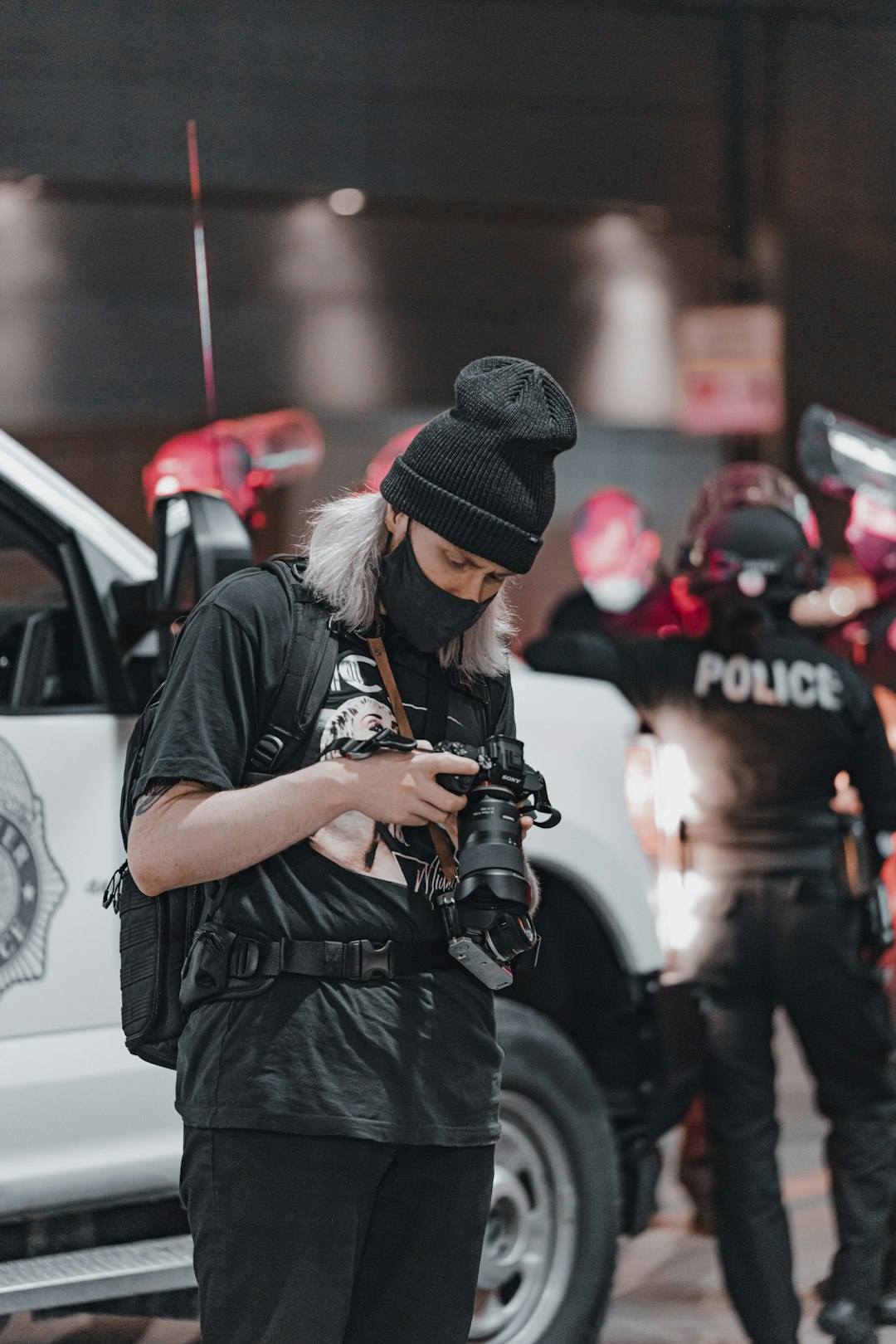 man in black t-shirt holding black dslr camera