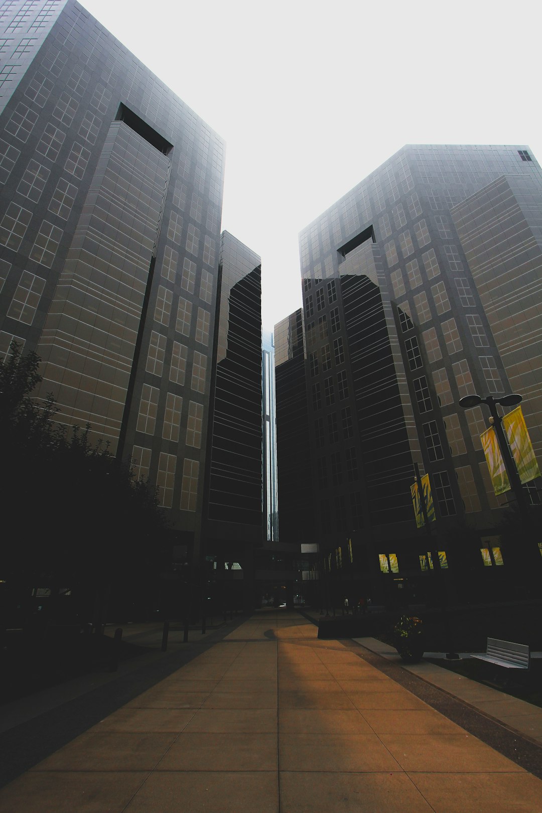 people walking on sidewalk near high rise buildings during daytime