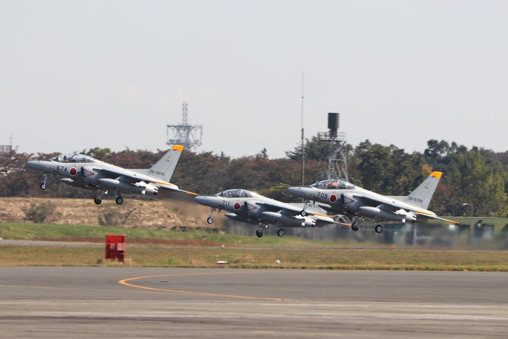 gray fighter plane on gray asphalt road during daytime