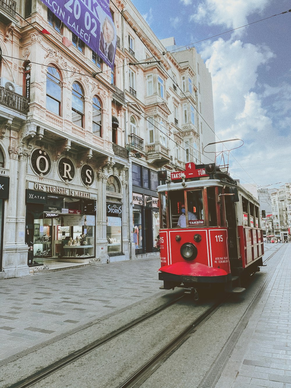 red and white tram on road near building during daytime