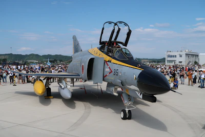 A fan proudly wearing an F-15EX Strike Eagle 2 graphic tee at an airshow.
