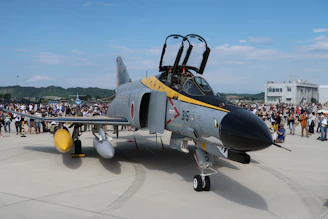 A fan proudly wearing an F-15EX Strike Eagle 2 graphic tee at an airshow.