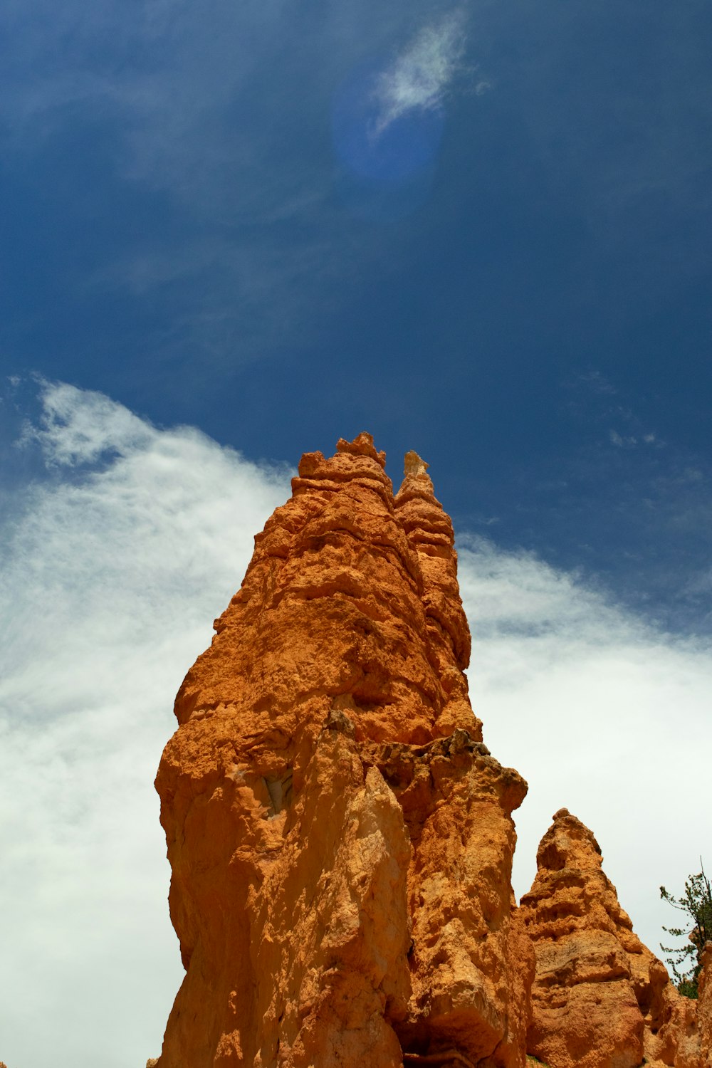 brown rock formation under blue sky and white clouds during daytime