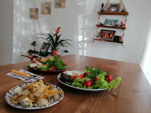 Warm-toned photo of a cozy Scandinavian-style restaurant table set with artisanal dishes and rustic pottery.