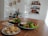 A bright and cozy home environment with healthy foods arranged on a wooden table.