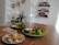 A bright and cozy home environment with healthy foods arranged on a wooden table.