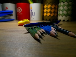 Close-up of premium gel pens and mechanical pencils laid out on a wooden surface.