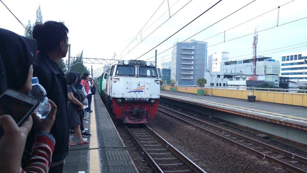 people standing on train station during daytime