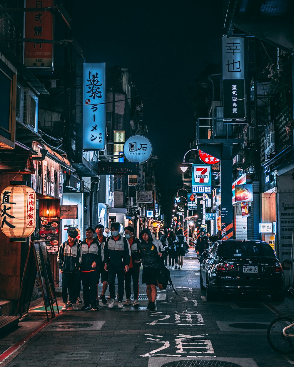 people walking on street during night time